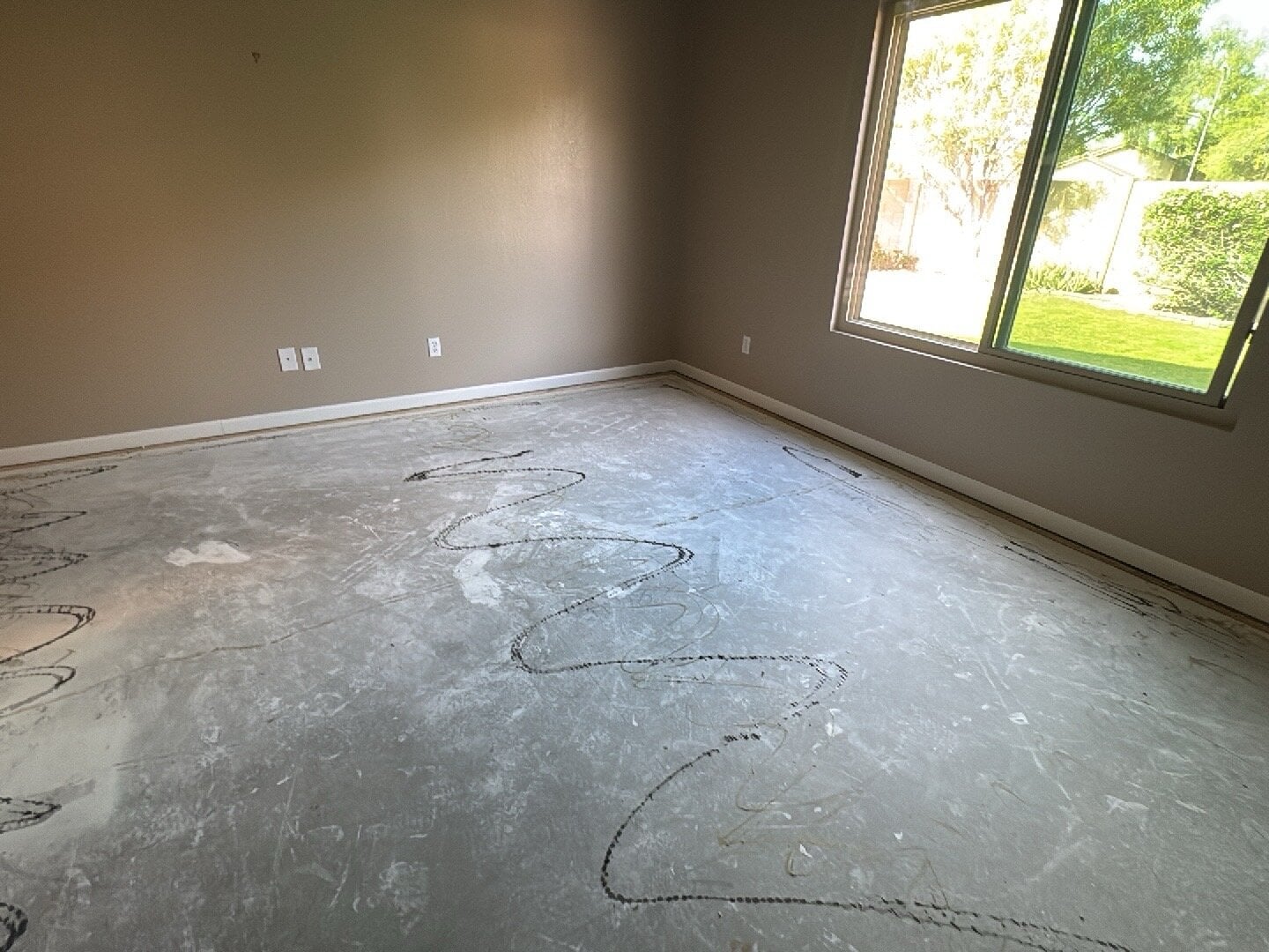 Empty room in Cave Creek, AZ with bare floor; perfect for water damage restoration projects.